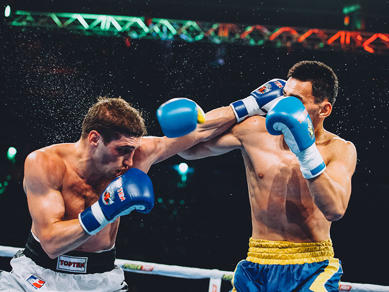 Two boxers throwing punches at each other during a professional fight
