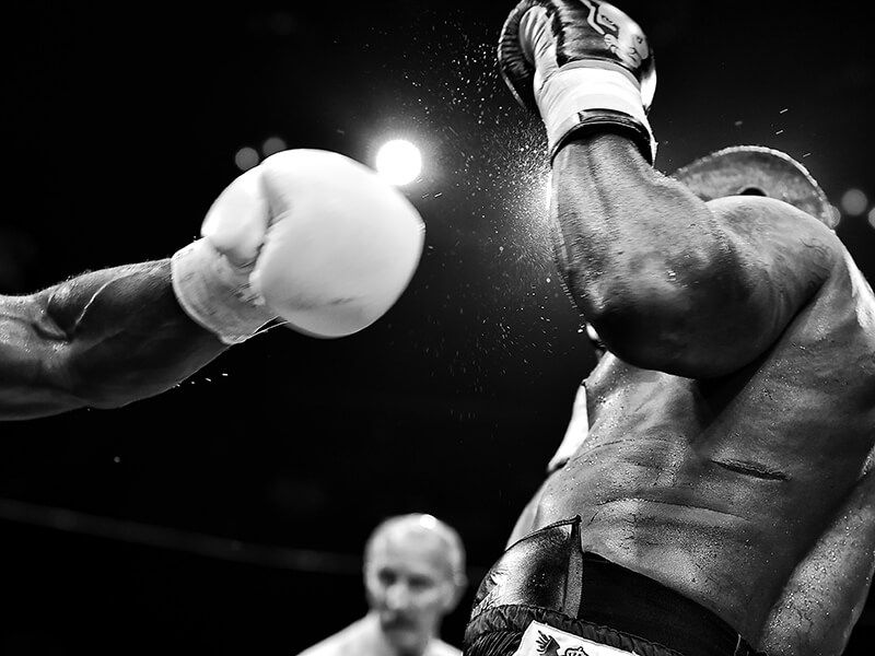 A boxer's glove after his punch has landed on his opponent